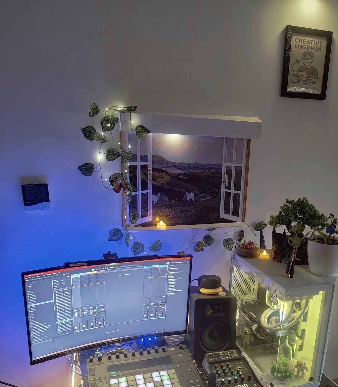 The desk in Anantnag: a curved display running Ableton Live, an Ableton Push, a MIDI keyboard, a small mixer, a studio monitor, plants and string lights